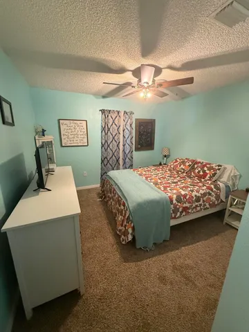 a bedroom with a bed and a chair