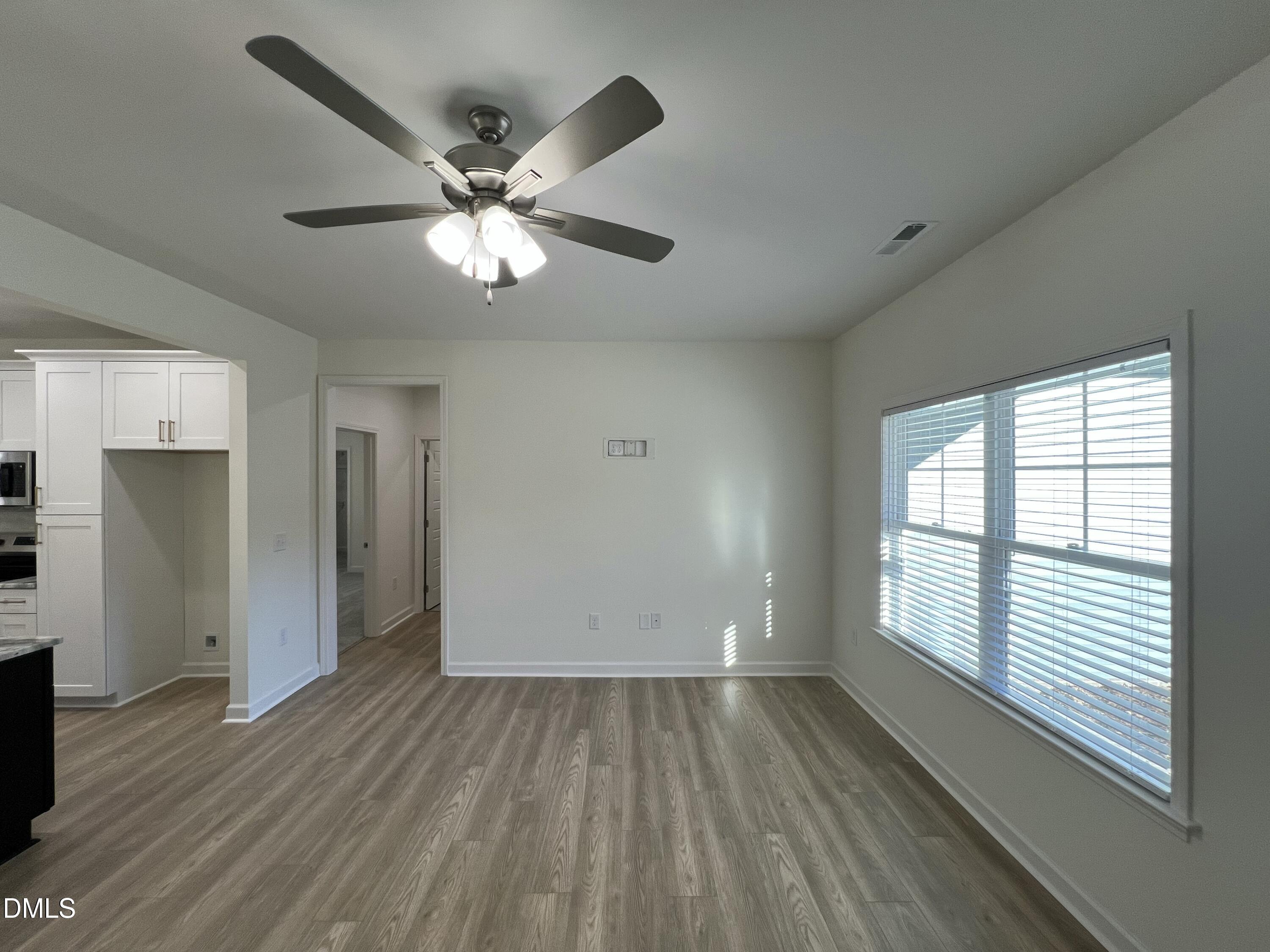 1552 Patterson Road Kinston, NC 28504 - Photo 4 of 23 a view of an empty room with wooden floor and a window
