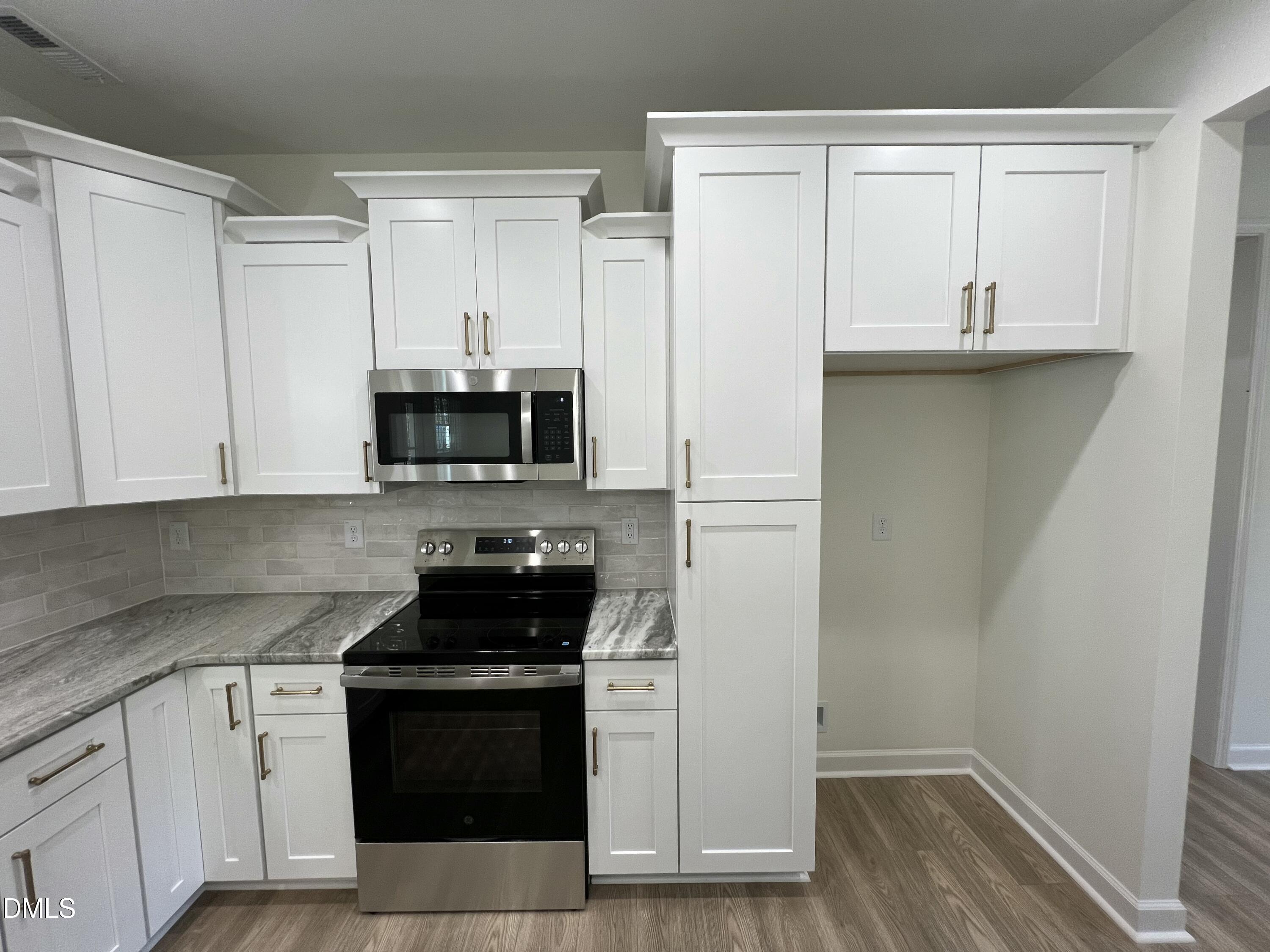 1552 Patterson Road Kinston, NC 28504 - Photo 6 of 23 a kitchen with white cabinets and black appliances