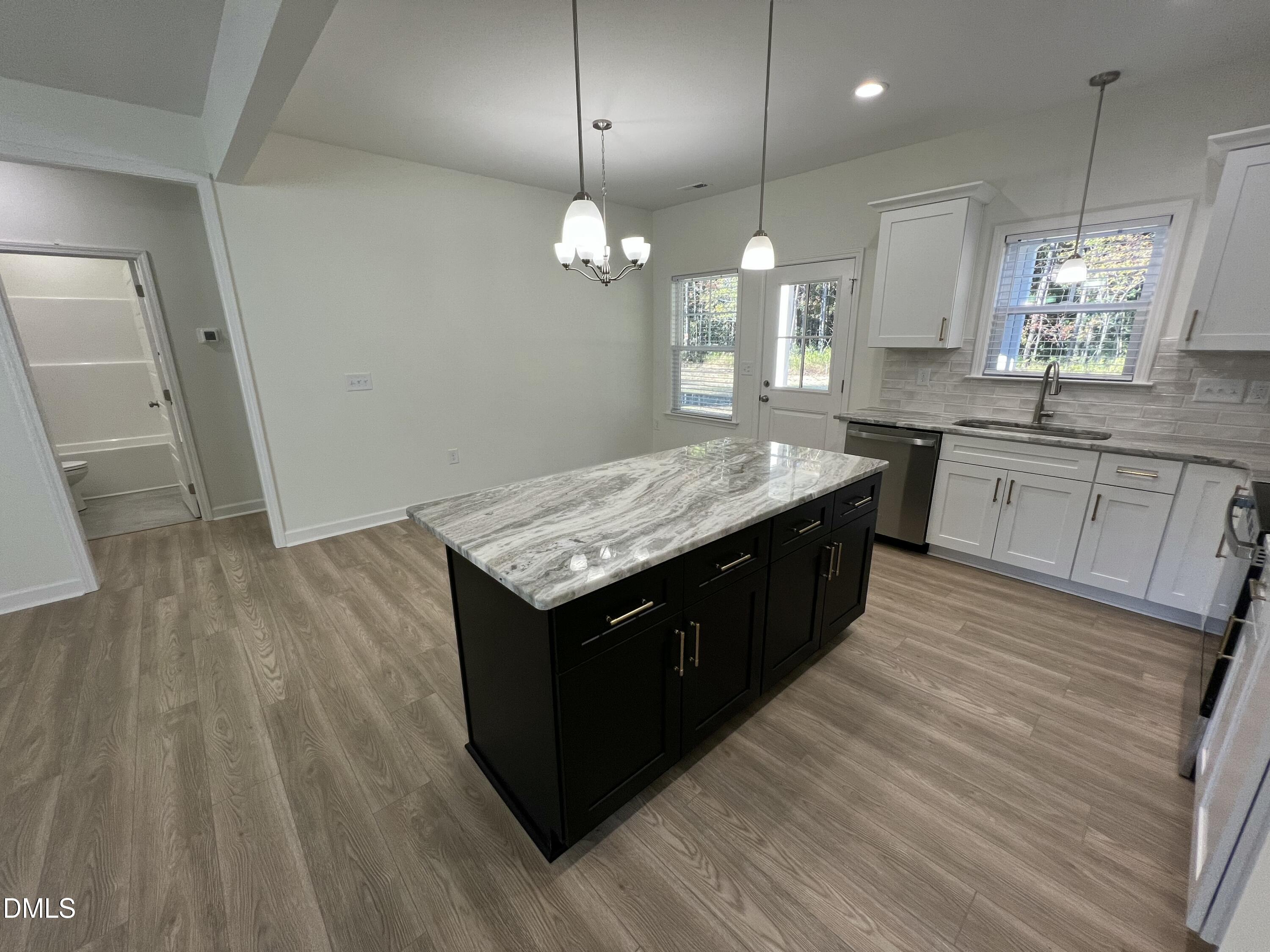 1552 Patterson Road Kinston, NC 28504 - Photo 8 of 23 a large kitchen with granite countertop a sink counter space and wooden floor