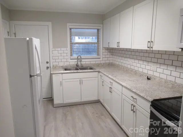 a kitchen with a sink stove and refrigerator