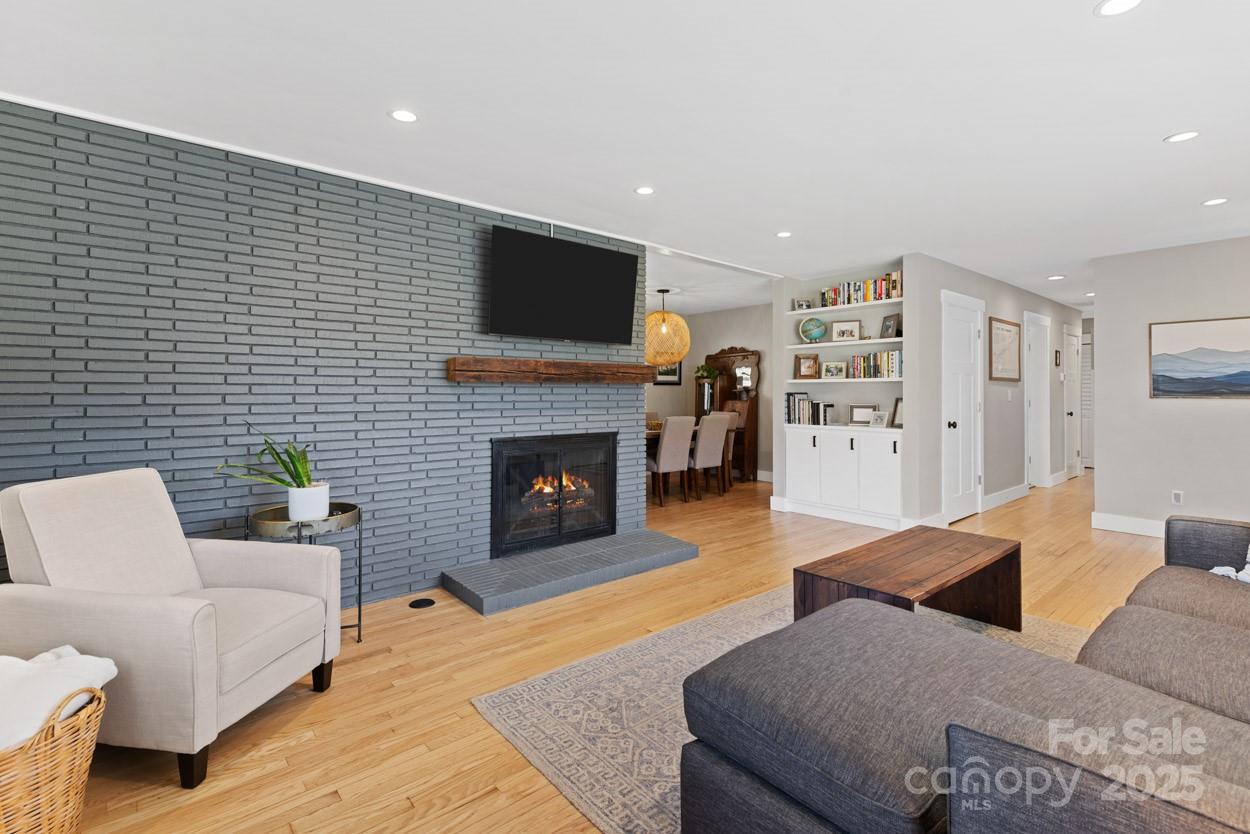 29 Willowbrook Road, Unit 11 Asheville, NC 28805 - Photo 11 of 46 a living room with furniture a flat screen tv and a fireplace