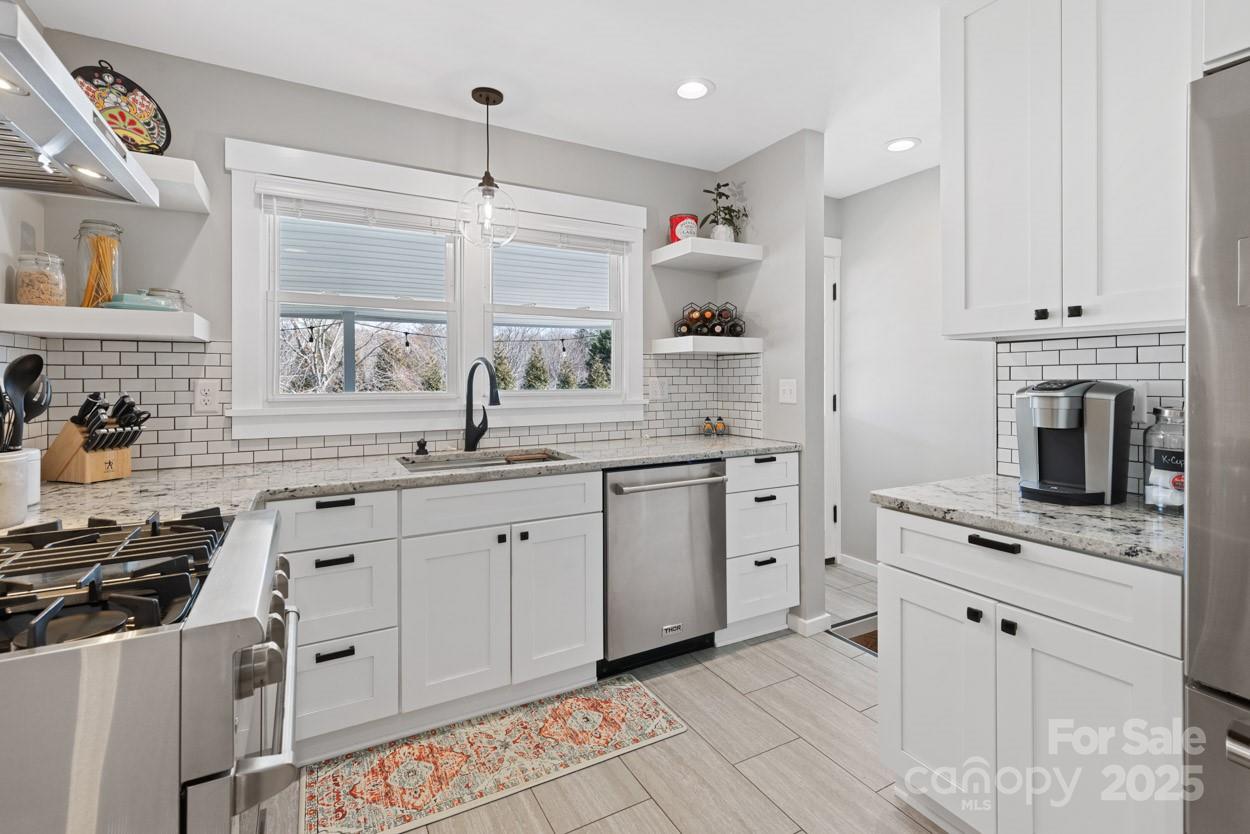 29 Willowbrook Road, Unit 11 Asheville, NC 28805 - Photo 14 of 46 a kitchen with white cabinets and appliances
