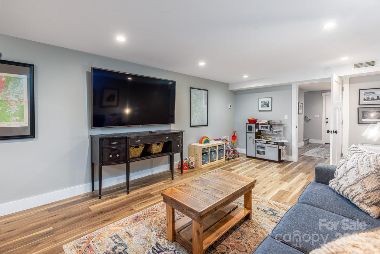 29 Willowbrook Road, Unit 11 Asheville, NC 28805 - Photo 24 of 46 a living room with furniture and a flat screen tv