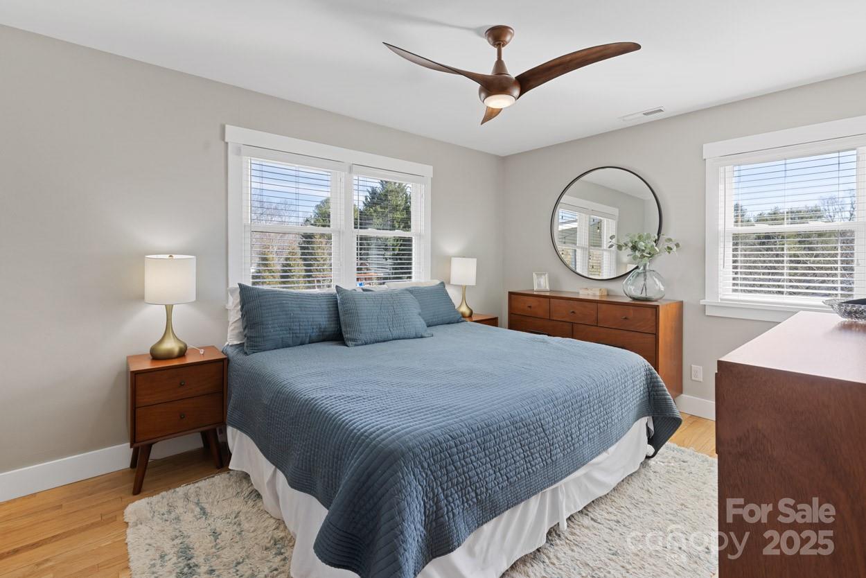 29 Willowbrook Road, Unit 11 Asheville, NC 28805 - Photo 28 of 46 a bedroom with a bed and a chandelier