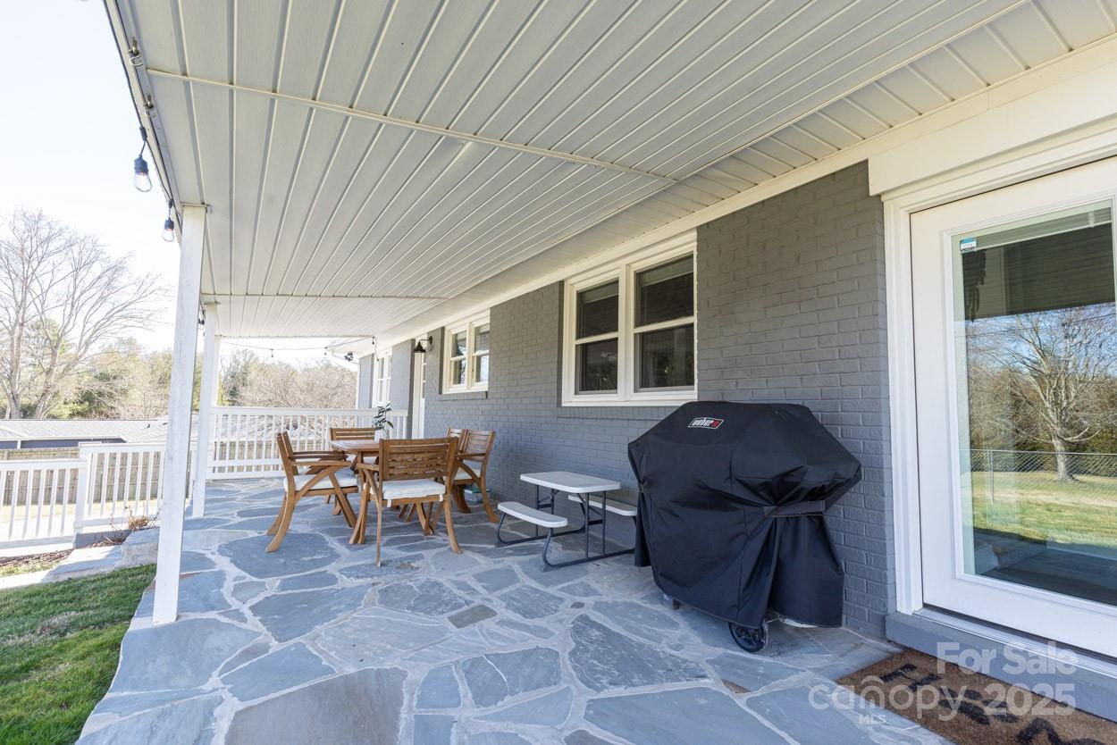 29 Willowbrook Road, Unit 11 Asheville, NC 28805 - Photo 35 of 46 a view of a patio with table and chairs