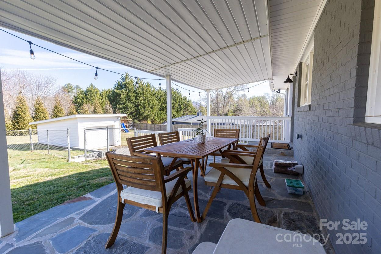 29 Willowbrook Road, Unit 11 Asheville, NC 28805 - Photo 36 of 46 a view of a patio with table and chairs