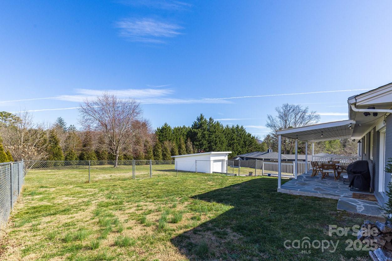 29 Willowbrook Road, Unit 11 Asheville, NC 28805 - Photo 38 of 46 a view of a big yard with a table and a chairs