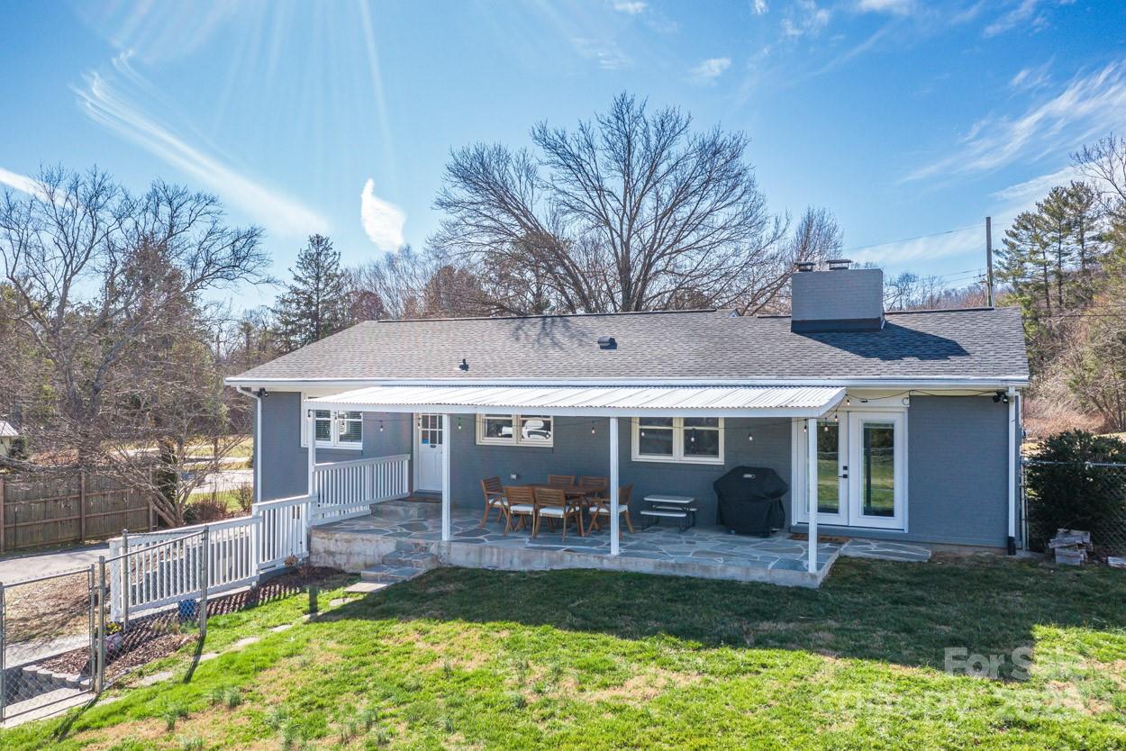 29 Willowbrook Road, Unit 11 Asheville, NC 28805 - Photo 4 of 46 a view of a house with a yard deck and a table and chairs