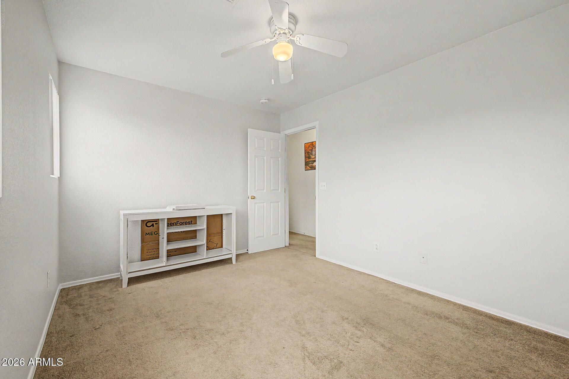 2607 West Bloch Road Phoenix, AZ 85041 - Photo 27 of 34 an empty room with closet and a chandelier fan