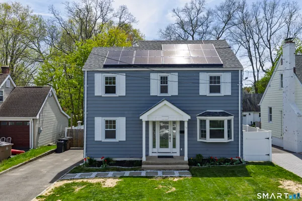 a front view of house with yard and green space