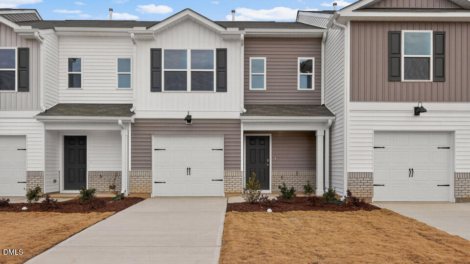 a front view of a house with yard