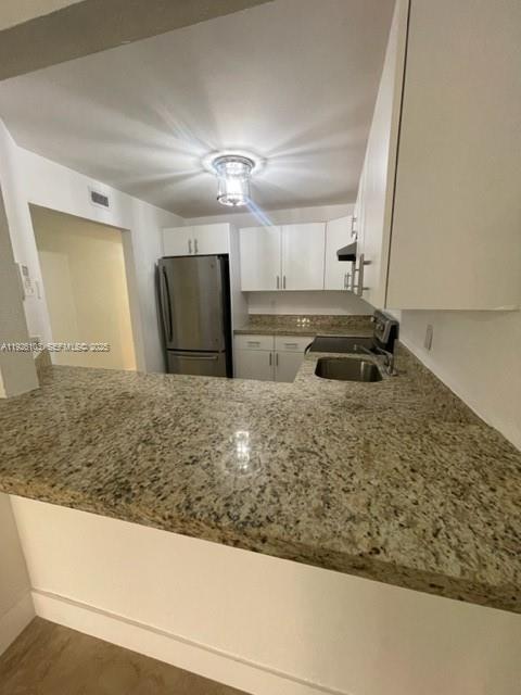 180 Royal Palm Road, Unit 109 Hialeah Gardens, FL 33016 - Photo 7 of 11 a view of kitchen and kitchen island