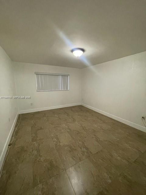 180 Royal Palm Road, Unit 109 Hialeah Gardens, FL 33016 - Photo 10 of 11 an empty room with a empty space and windows