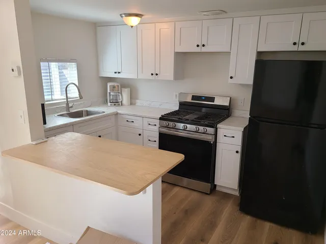 a kitchen with granite countertop cabinets and steel stainless steel appliances