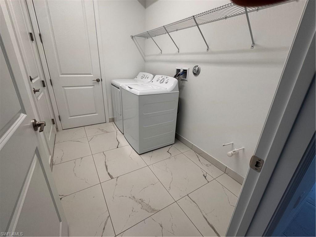 2864 Bloomfield Way Naples, FL 34112 - Photo 12 of 40 a utility room with cabinets