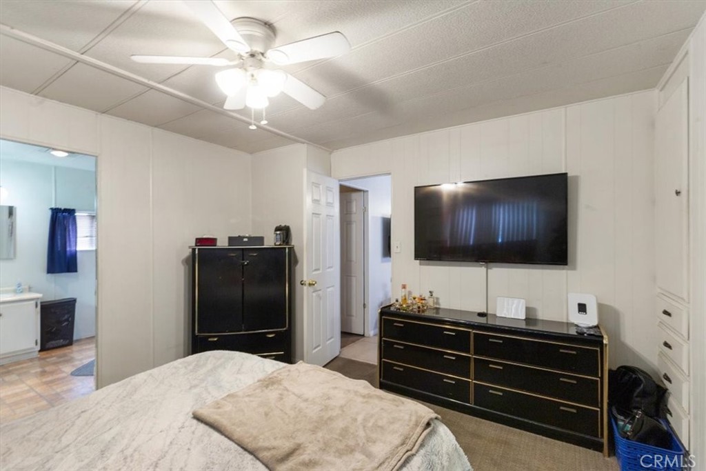 300 North Rampart Street, Unit 195 Orange, CA 92868 - Photo 19 of 25 a room with a bed and a flat screen tv
