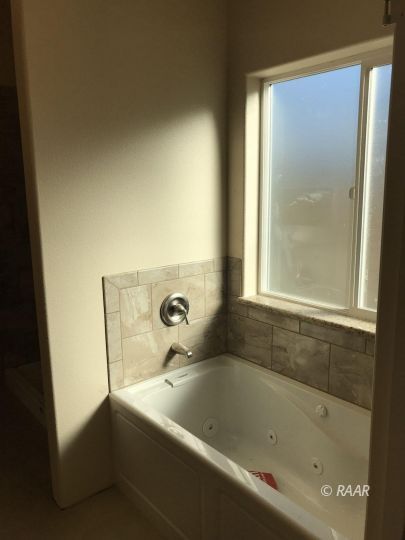 425 Randall Street Ridgecrest, CA 93555 - Photo 24 of 27 a bath tub sitting next to a window