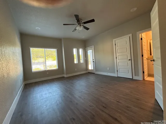 a view of a livingroom with wooden floor and a window