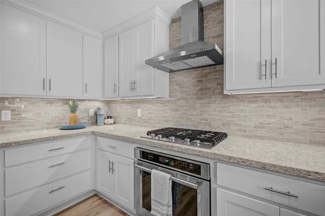 a living room with furniture large windows and a chandelier