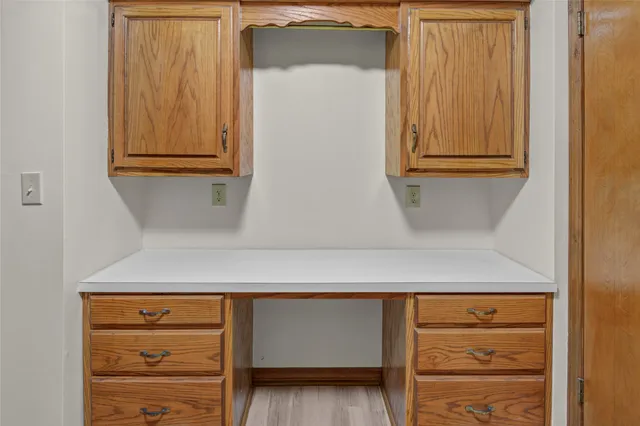 a spacious bedroom with a bed and a large window