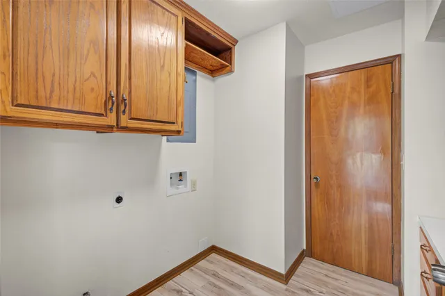 a spacious bedroom with a bed and a chandelier