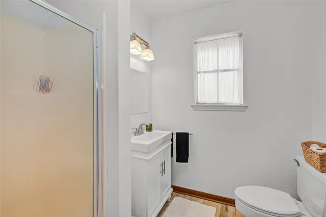 a spacious bathroom with a granite countertop sink and a mirror