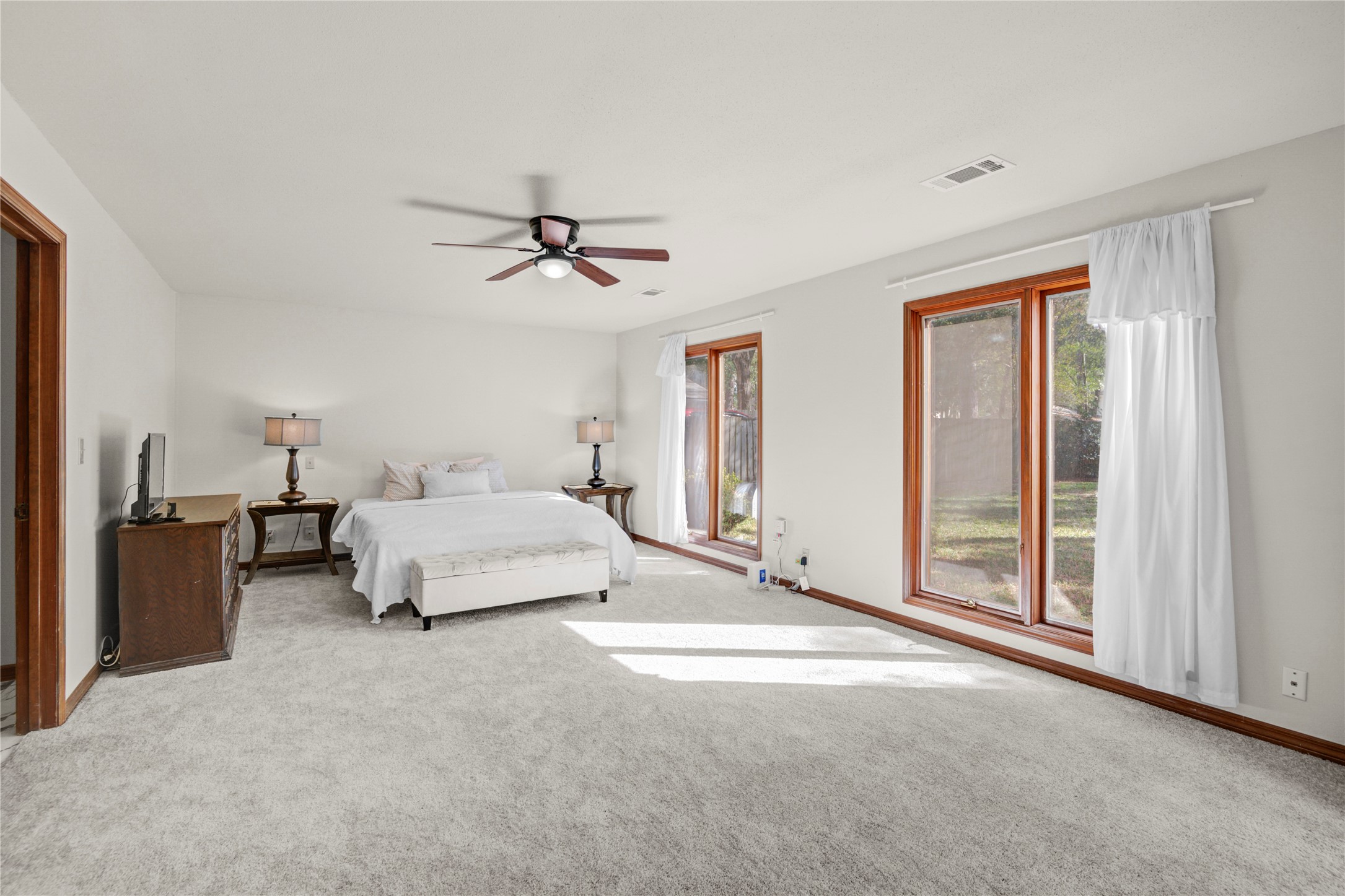 6711 River Lodge Drive Spring, TX 77379 - Photo 20 of 39 a spacious bedroom with a bed and a chandelier