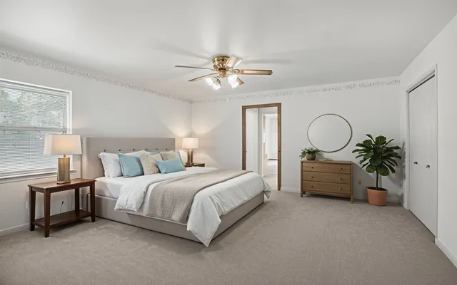 a view of a workspace with furniture and a fan