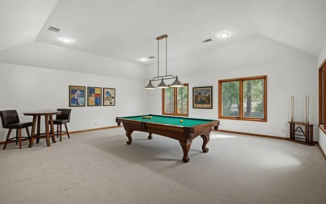 a front view of house with yard and trees in the background