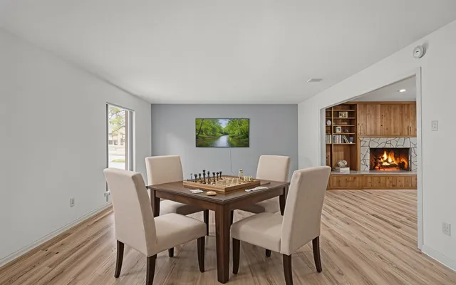 a view of a dining room with furniture and wooden floor