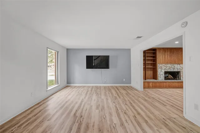 wooden floor in an empty room with a window