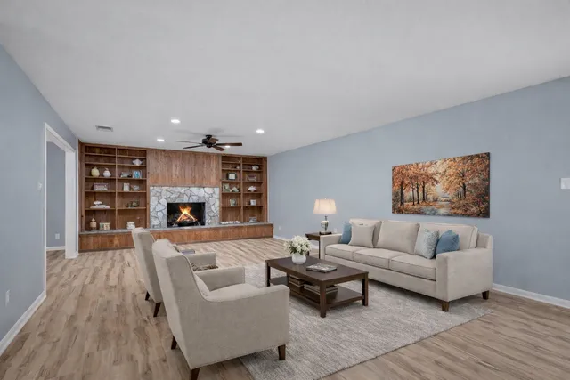 a living room with furniture and a fireplace