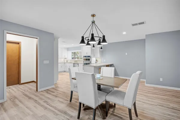 a kitchen with stainless steel appliances granite countertop a kitchen island hardwood floor sink stove and wooden floor