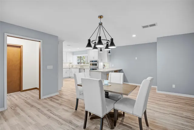 a kitchen with kitchen island granite countertop a sink a center island and cabinets