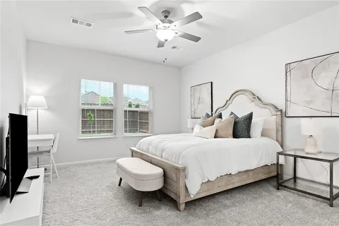 a bedroom with a bed wooden floor and window