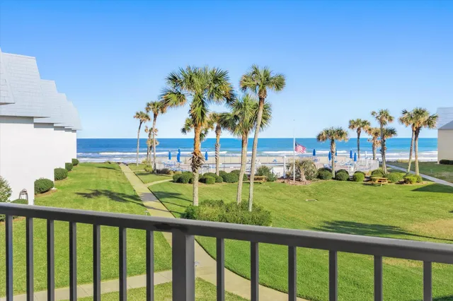 a view of swimming pool from a balcony with outdoor space