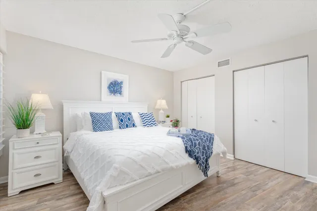 a bed room with a bed television and a large window