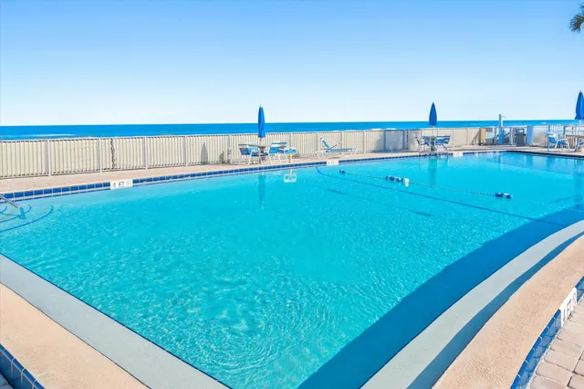 a view of a swimming pool with a lawn chairs
