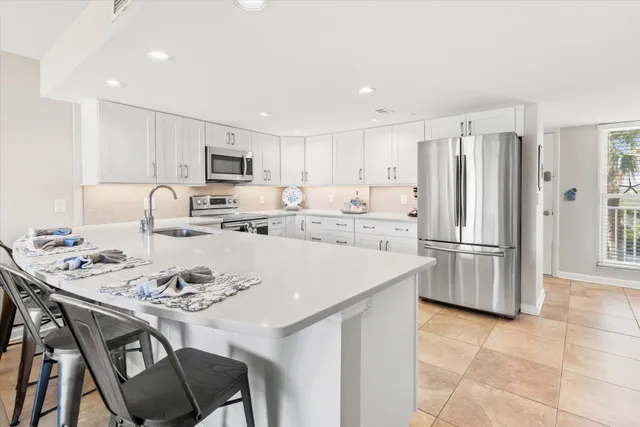 a kitchen with a sink and a refrigerator