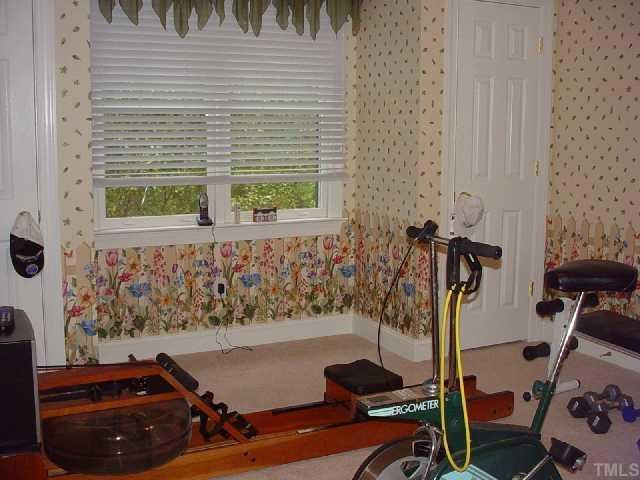 5916 Rock Canyon Road Raleigh, NC 27613 - Photo 10 of 12 Look beyond the exercise equipment and visualize the cheery guest room that this truly is. Notice the double closets. Window woud be perfect for a window seat. Again, the possibilities are endless.... Bedroom