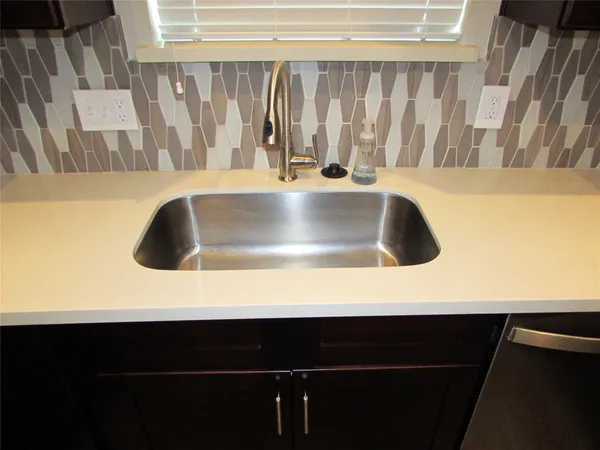 a kitchen with a refrigerator and a sink