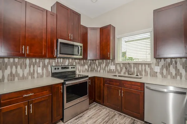 a kitchen with wooden cabinets and a stove top oven