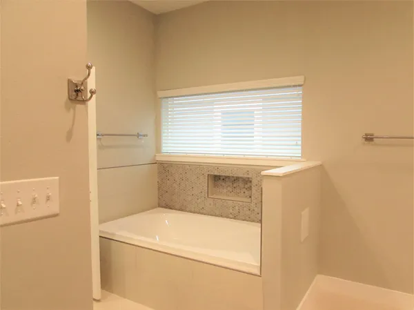 a bathroom with a tub and shower