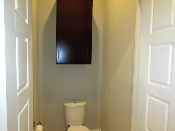 an empty room with a fan and a window