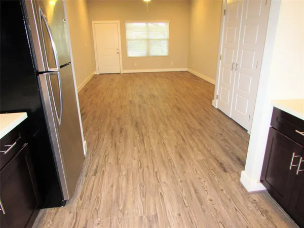 a view of kitchen with refrigerator microwave and stove