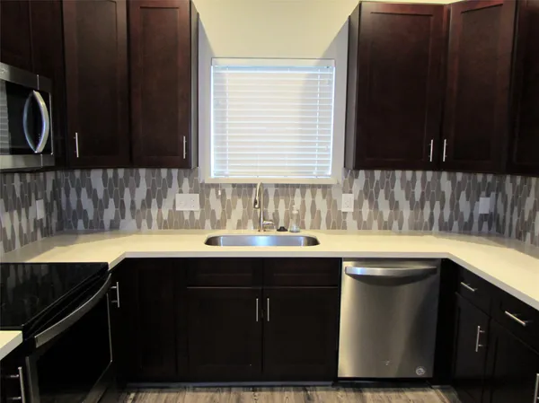 a kitchen with a sink and a window