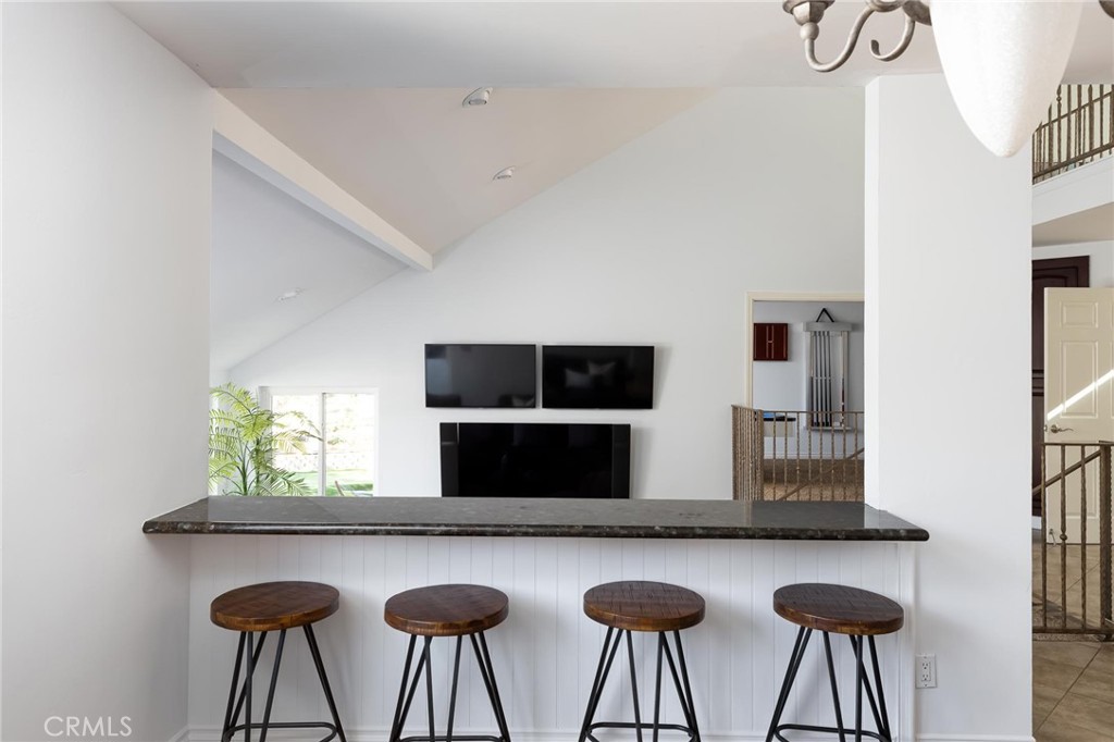 14026 Donart Drive Poway, CA 92064 - Photo 6 of 14 a kitchen with stainless steel appliances a kitchen island a table and chairs in it