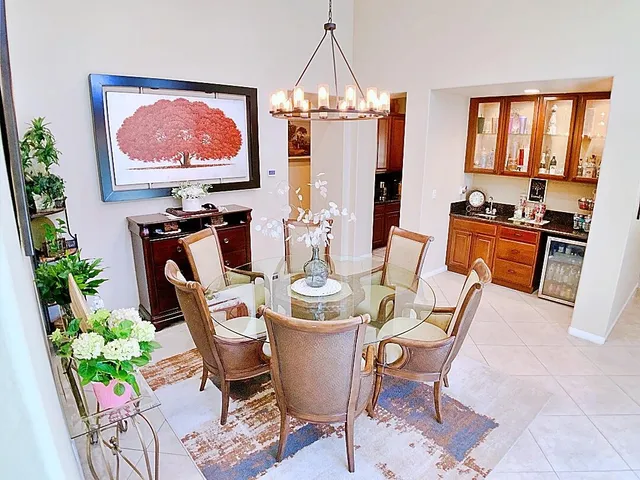 a dining room with furniture potted plants and wooden floor