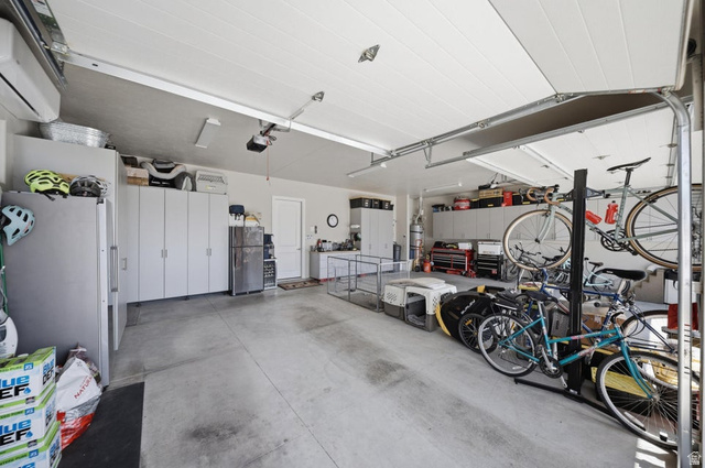 2829 East 1880th Street South St. George, UT 84790 - Photo 31 of 54 Garage with freestanding refrigerator and a mini split for heating / cooling